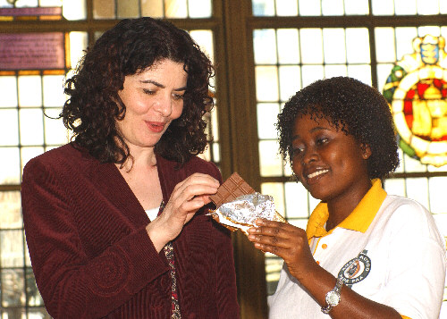 Erica Kyere tempts Diana Johnson, MP for Hull North, with chocolate from Divine / Kuapa Kokoo